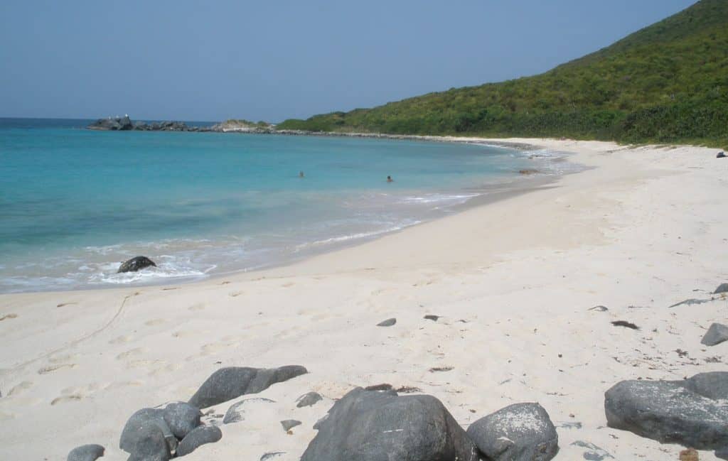 caribbean beach with sand, sea and rocks
