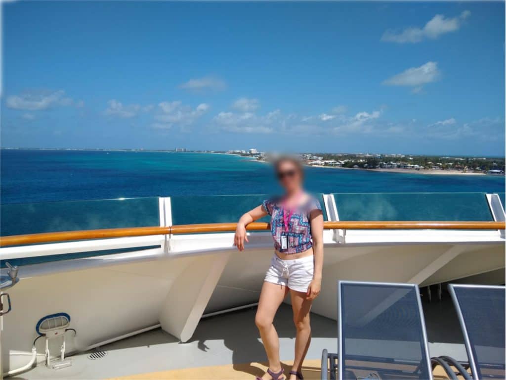 Woman standing on a cruise ship during a nude vacation