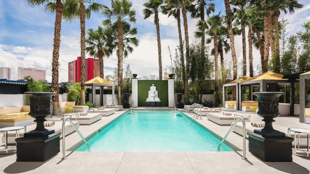 topless optional swimming pool in Las Vegas surrounded by palm trees and cabanas